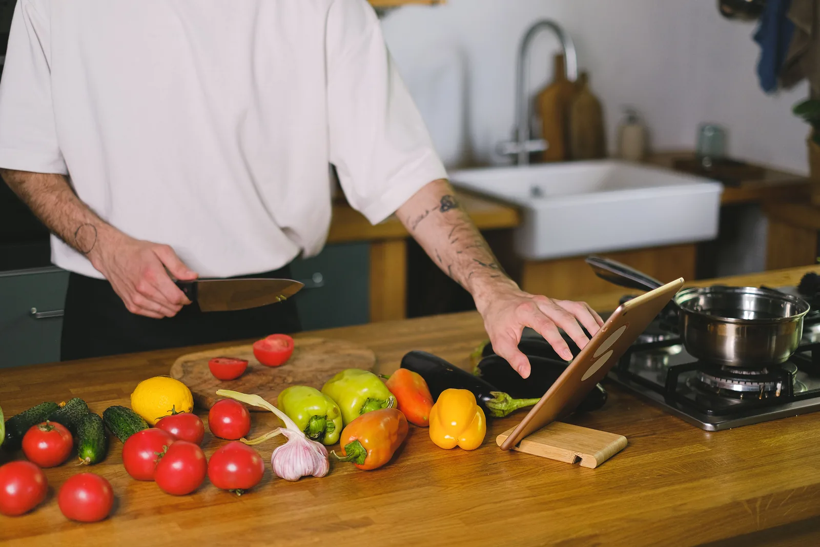 Home repair provider using a tablet at a kitchen counter during a customer estimate