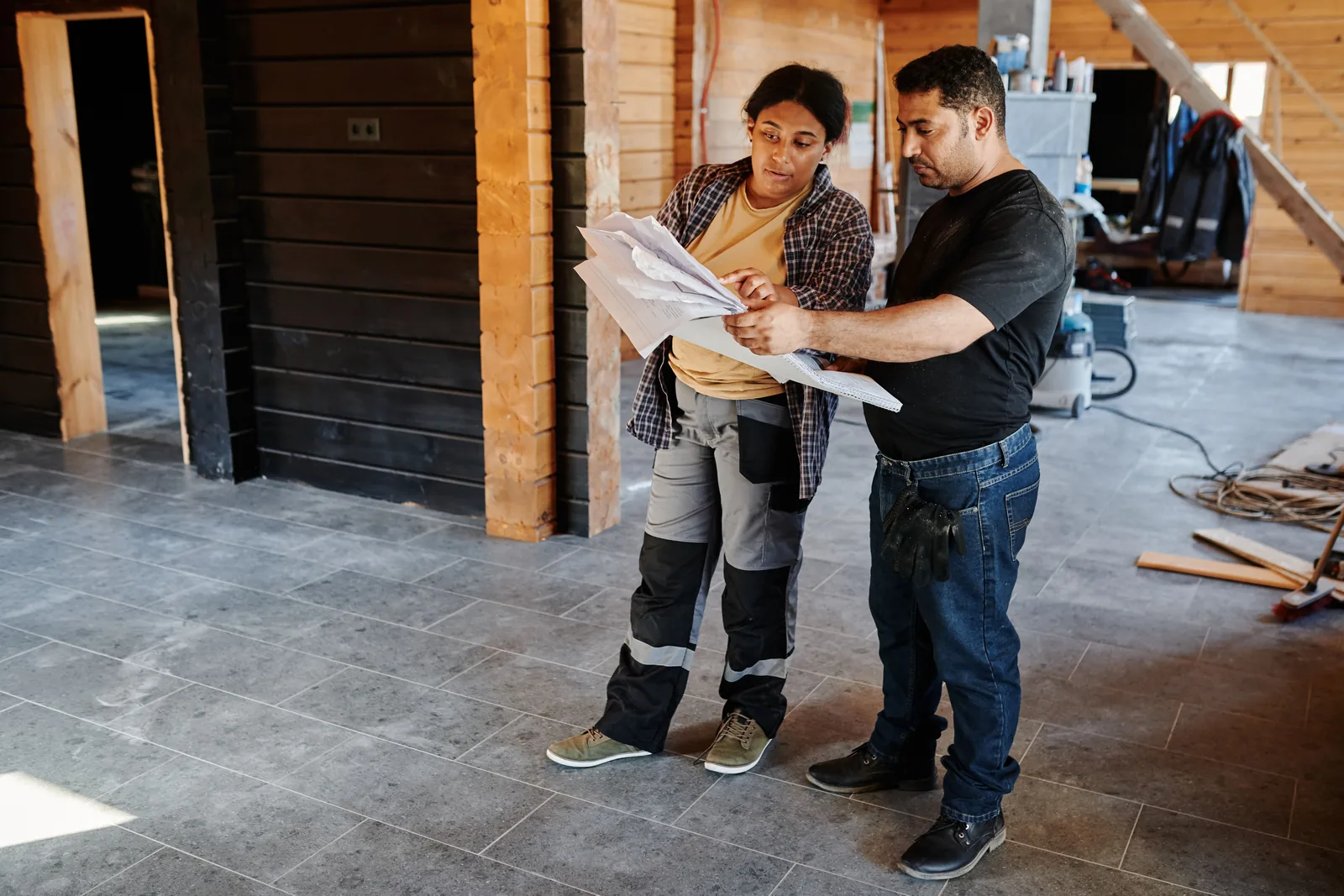 Contractor reviewing job site photos on a tablet before preparing an estimate